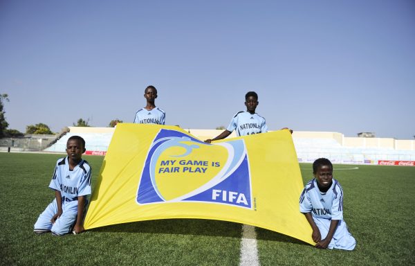 fairplay Ball boys hold a FIFA Fair Play banner before the opening match of the Somali premier league's new season at Banadir stadium, in Abdiaziz district of the capital Mogadishu on December 19, 2014. The match was between Elman FC and Horseed FC. This was during the openingSports in Somalia is recovering attracting foreign players as a result of the relative peace and progress witnessed in the country. AMISOM Photo / Ilyas Ahmed